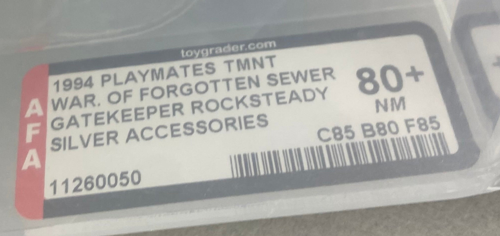 Teenage Mutant Ninja Turtles Gatekeeper Rock Steady Silver Weapons boxed figure AFA graded 80+. Label photo close-up.