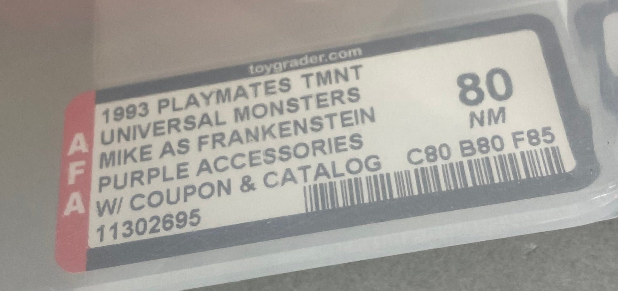 Teenage Mutant Ninja Turtles Mike as Frankenstein Universal Studios Monster boxed figure AFA graded 80. Label photo close-up.